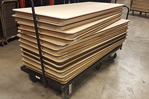 Bad stack of tables-wrong side up and unevenly stacked.